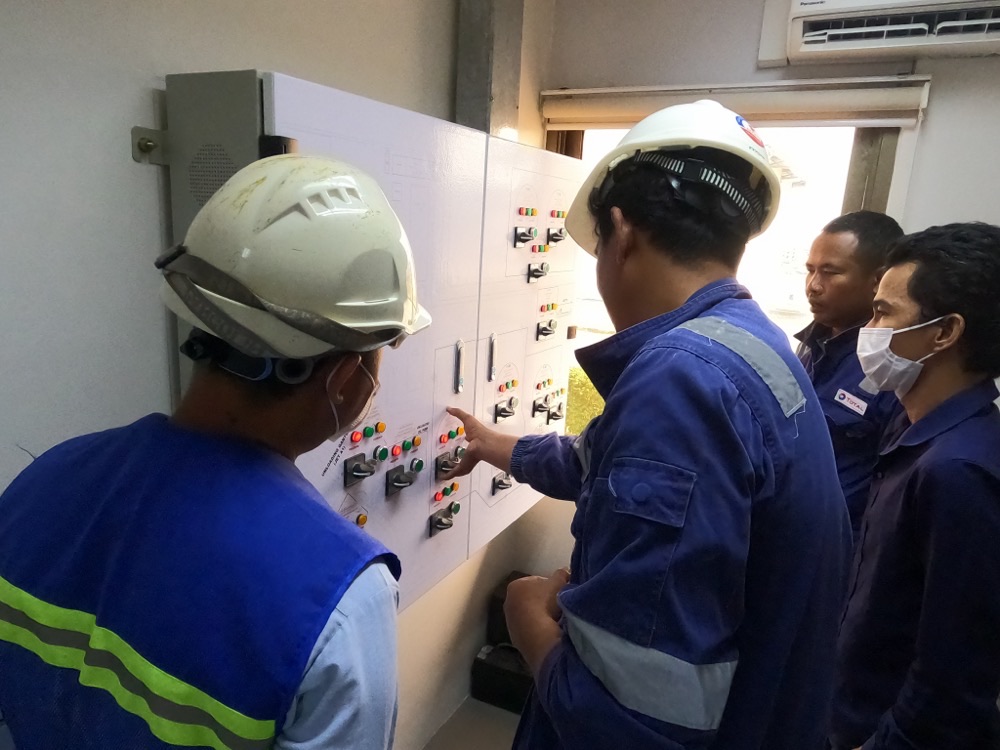 MBA engineers operating a control panel
